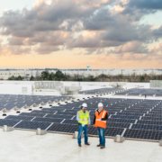 O3 team standing on top of a building with solar panels