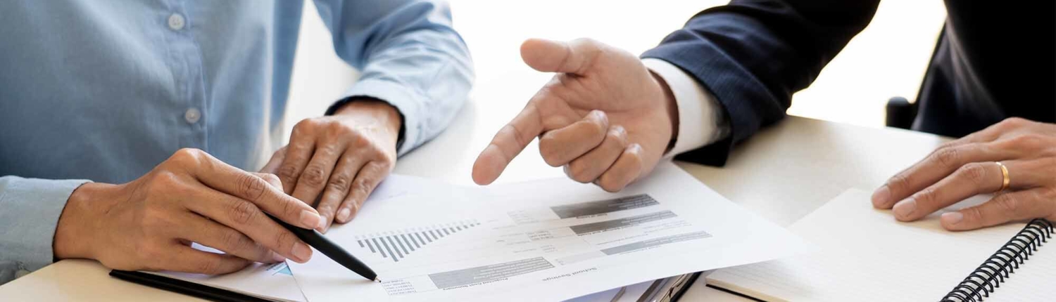 Whats the Difference Between PV Asset Managment and PV O&M August Blog 2 Two people in business casual attire pointing at a piece of paper